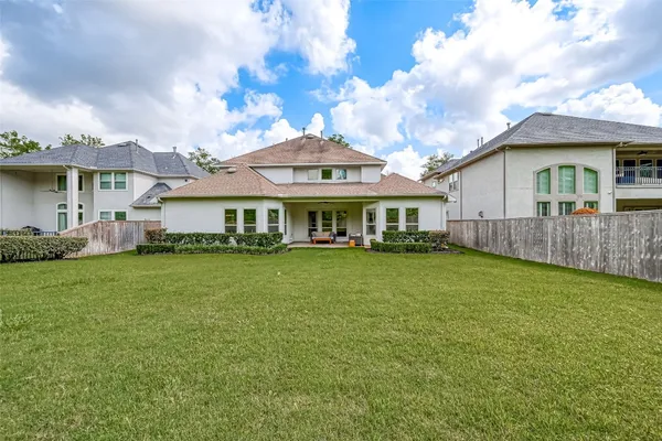 a front view of a house with yard and green space