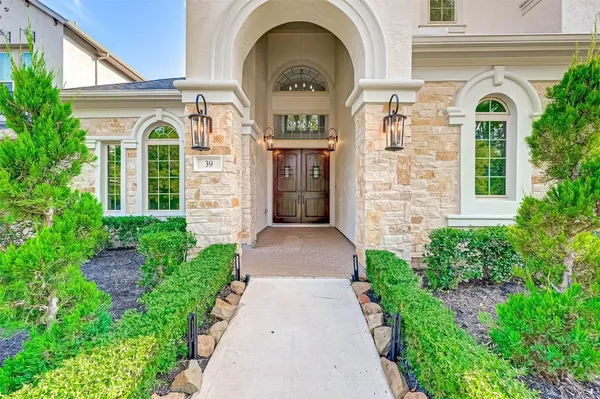 a view of a brick house with potted plants