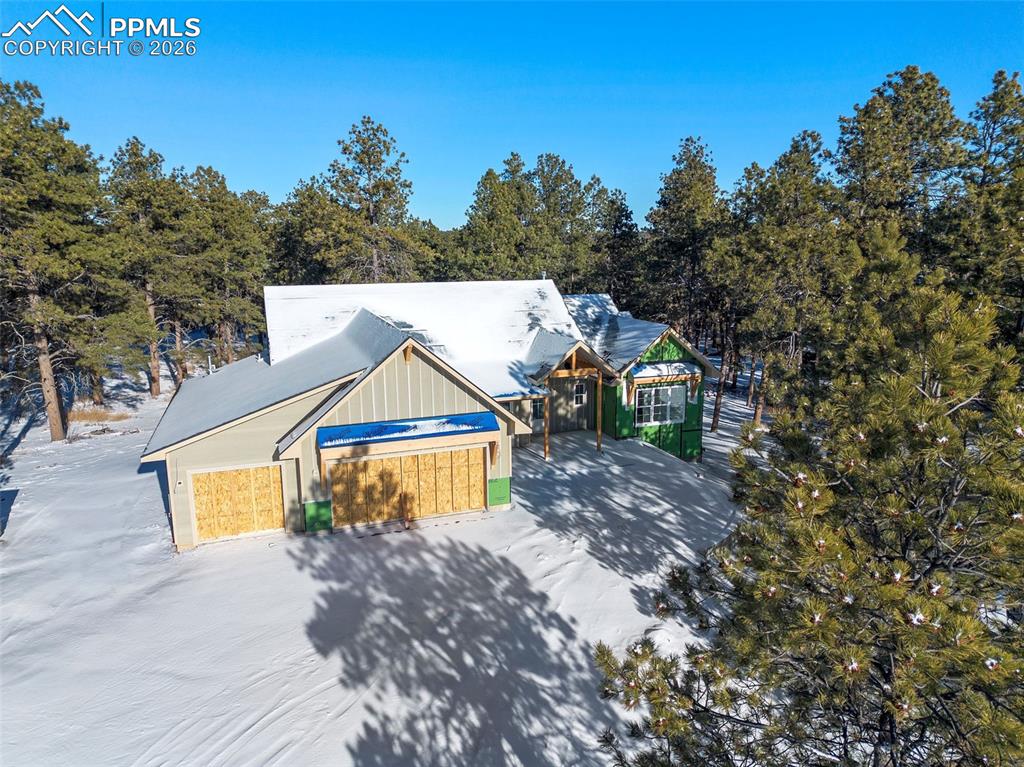 10697 Alamar Way Colorado Springs, CO 80908 - Photo 3 of 24 a aerial view of a house with swimming pool and trees in the background