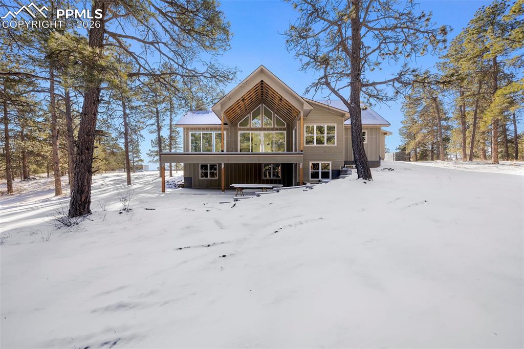 10697 Alamar Way Colorado Springs, CO 80908 - Photo 10 of 24 a front view of a house with a yard covered in snow