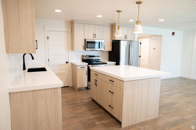 2218 South 635 West, Unit A Perry, UT 84302 - Photo 3 of 18 Modern kitchen featuring wood-finish cabinetry, stainless steel appliances, and white countertops