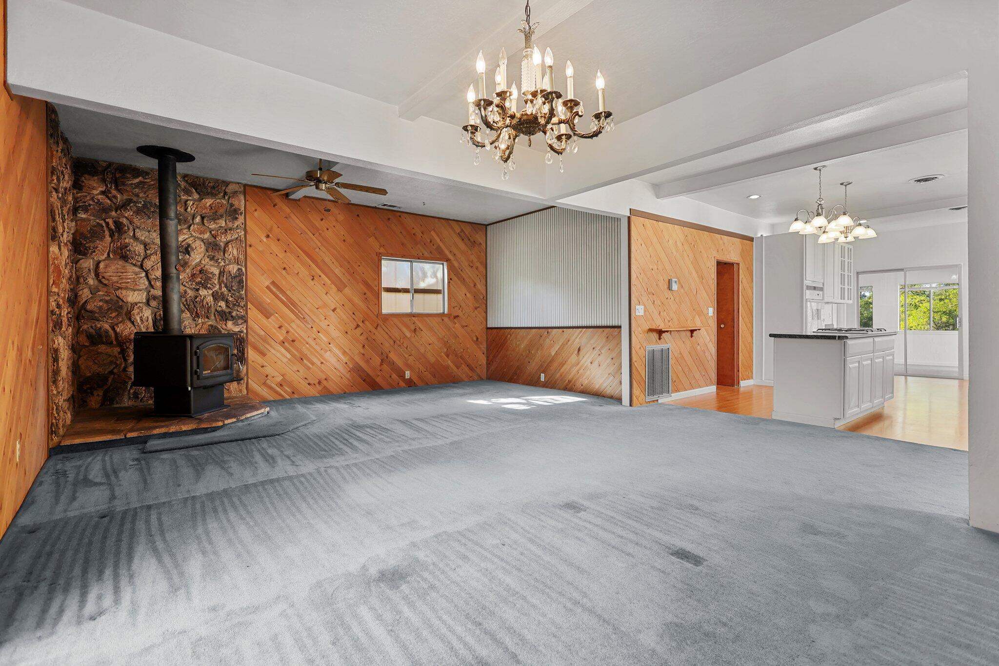 16588 Stanislaus Drive Redding, CA 96001 - Photo 12 of 53 a view of empty room with a fireplace and chandelier fan