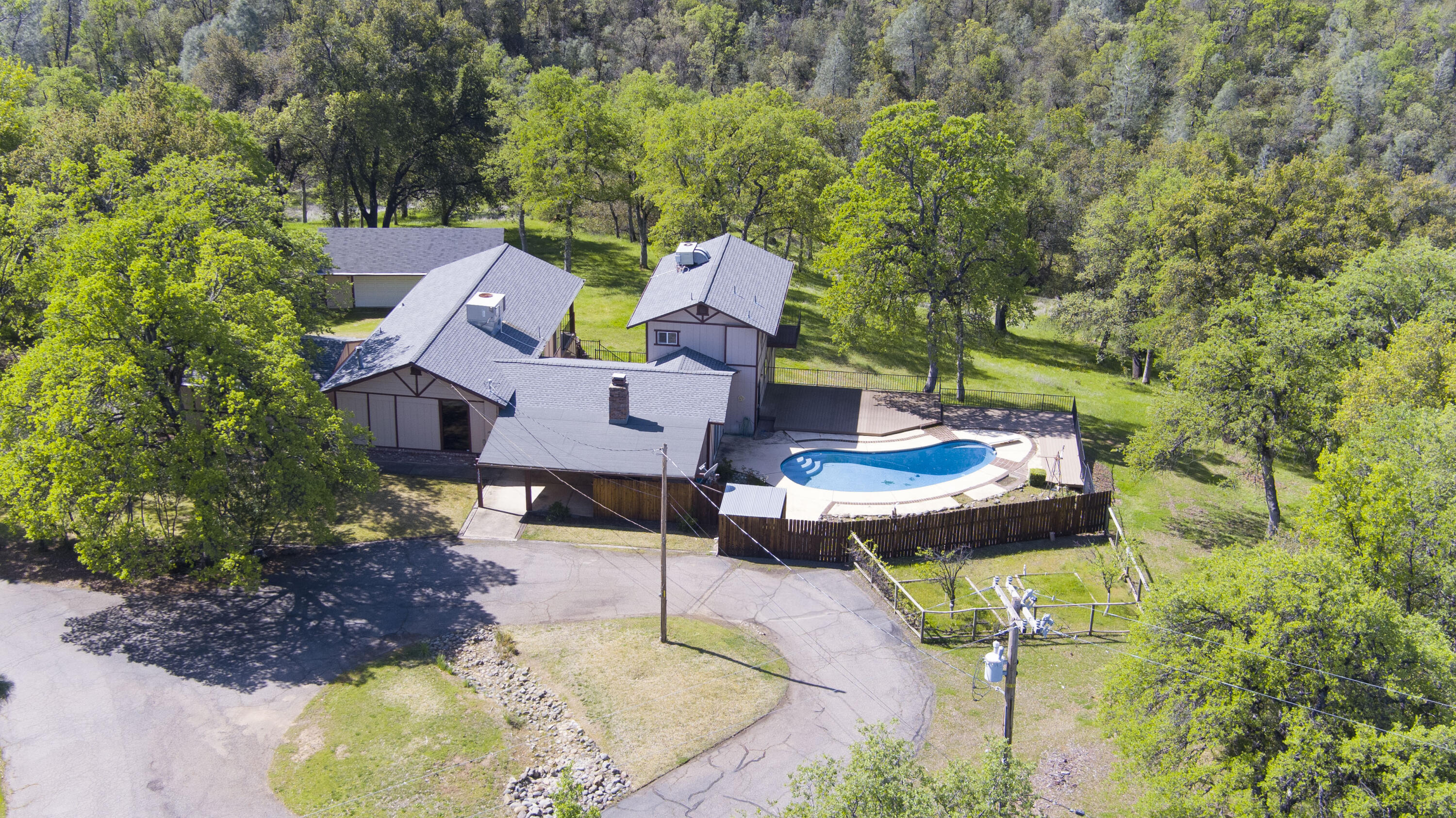 16588 Stanislaus Drive Redding, CA 96001 - Photo 2 of 53 a aerial view of a house with swimming pool and garden