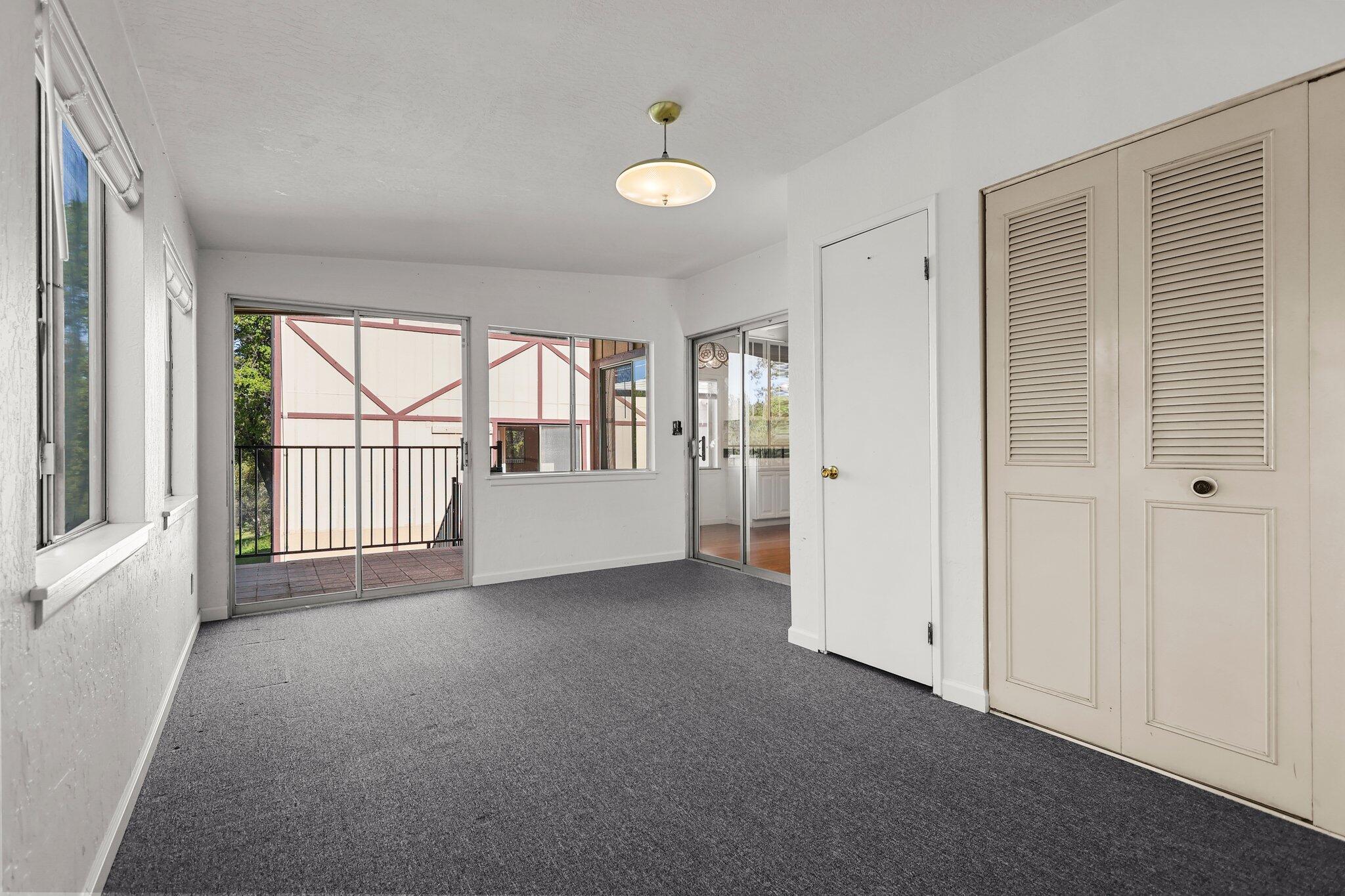 16588 Stanislaus Drive Redding, CA 96001 - Photo 21 of 53 an empty room with windows and entrance