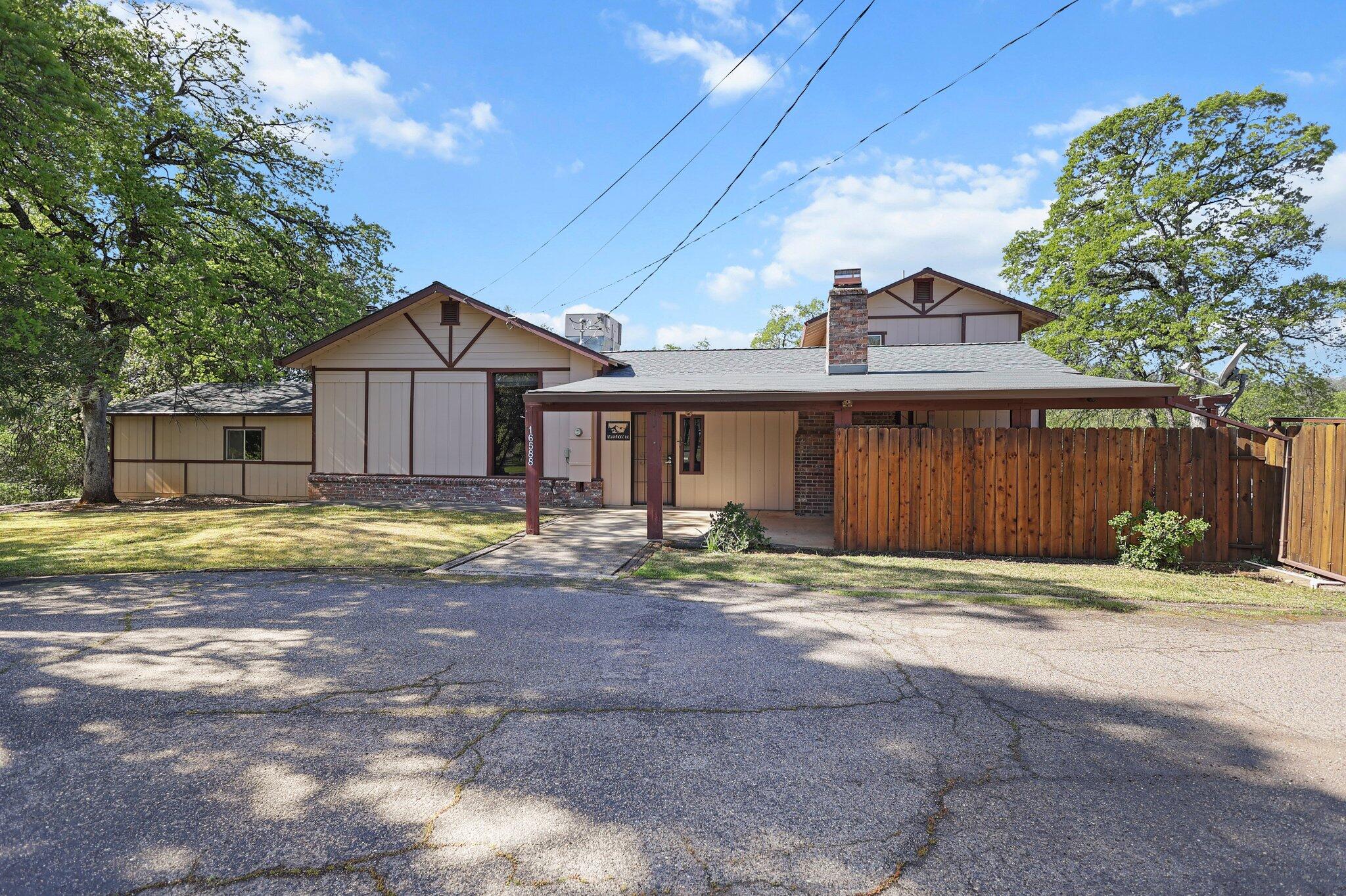 16588 Stanislaus Drive Redding, CA 96001 - Photo 3 of 53 a view of a house with a yard and large tree