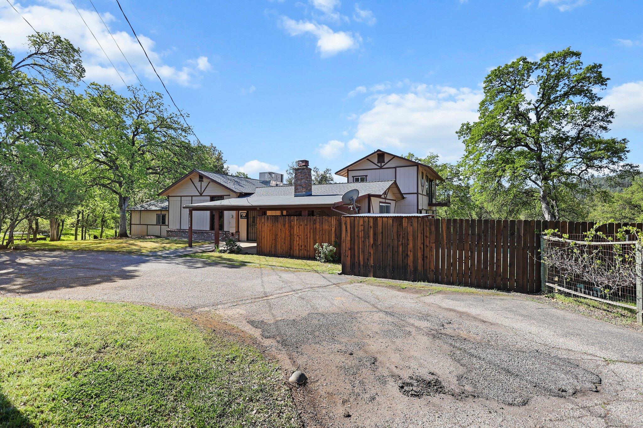 16588 Stanislaus Drive Redding, CA 96001 - Photo 47 of 53 a front view of a house with a yard and trees