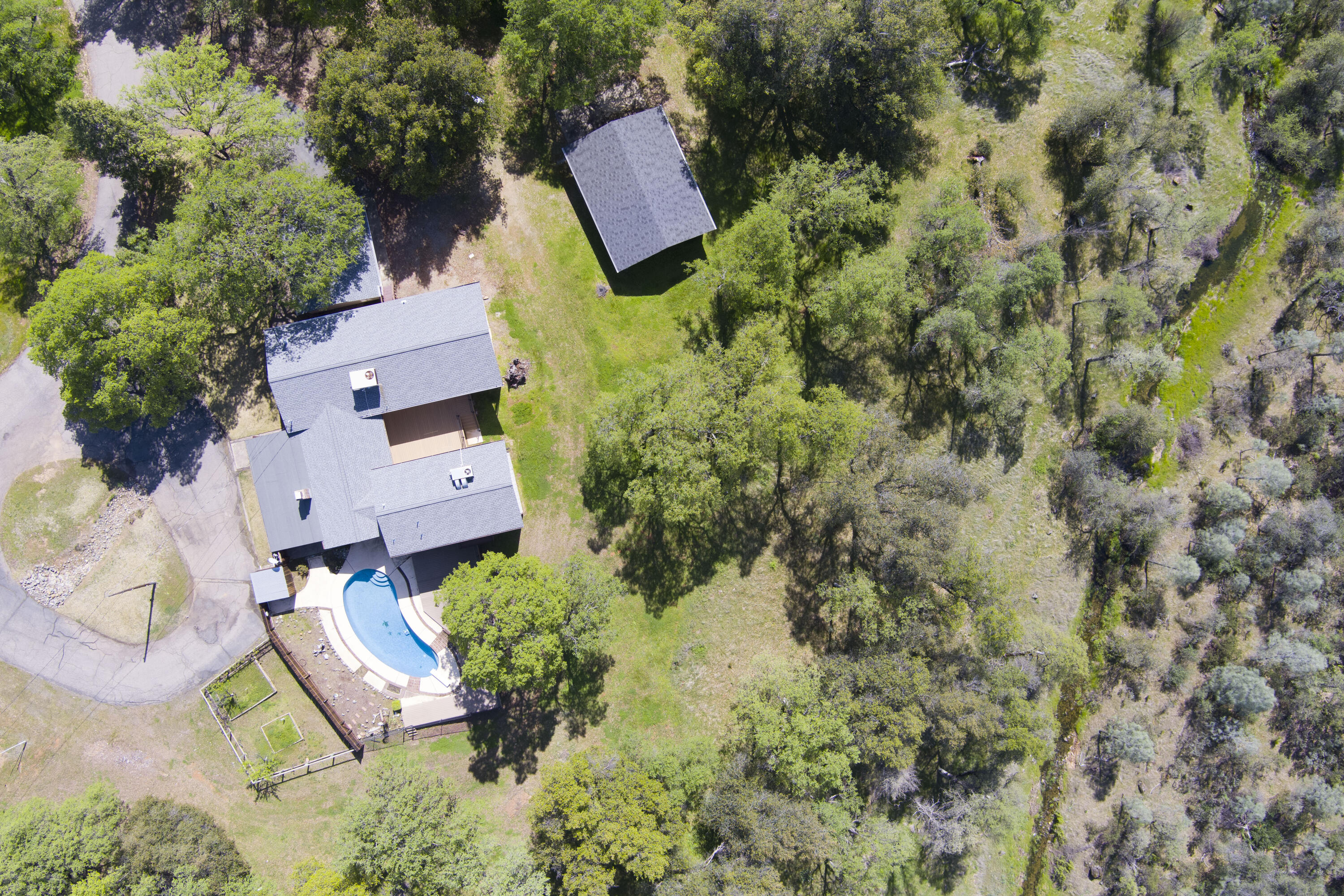 16588 Stanislaus Drive Redding, CA 96001 - Photo 52 of 53 an aerial view of a house with a yard and lake view
