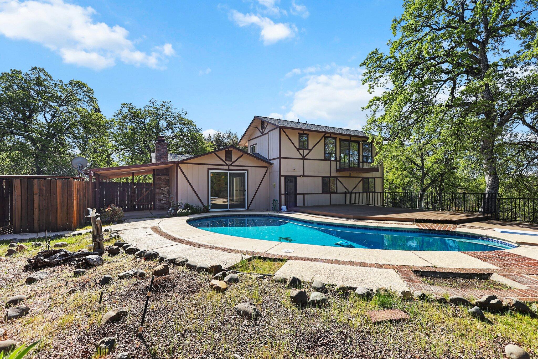 16588 Stanislaus Drive Redding, CA 96001 - Photo 6 of 53 a view of a backyard with table and chairs under an umbrella