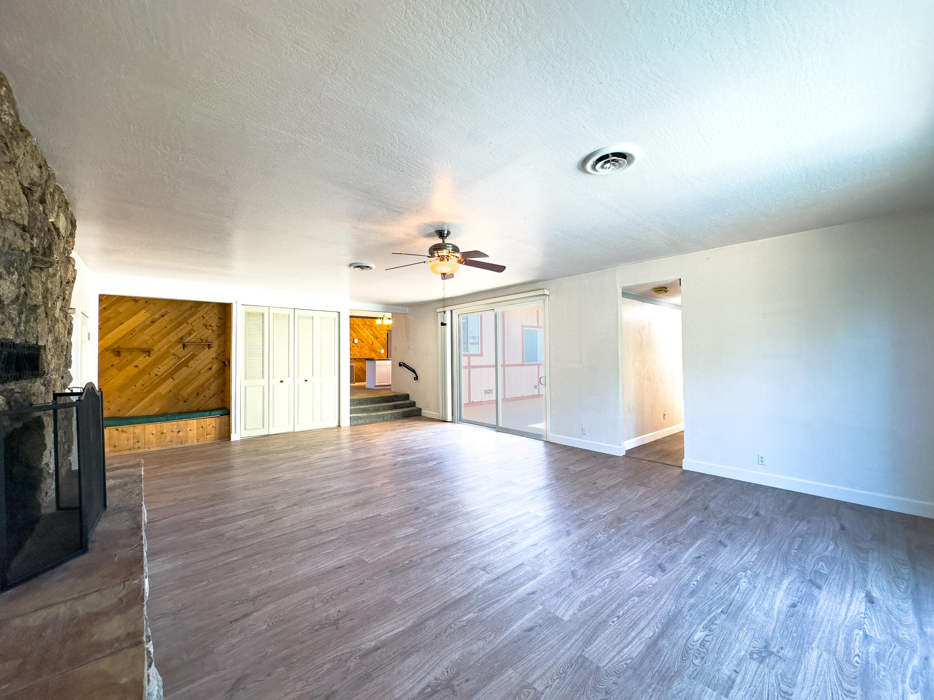 16588 Stanislaus Drive Redding, CA 96001 - Photo 10 of 53 a view of an empty room with window and wooden floor