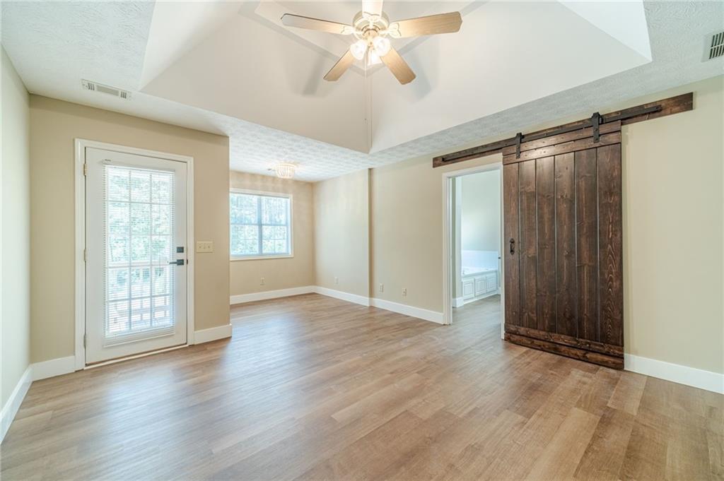 246 Azalea Farms Road Social Circle, GA 30025 - Photo 15 of 27 a view of an empty room with window and wooden floor