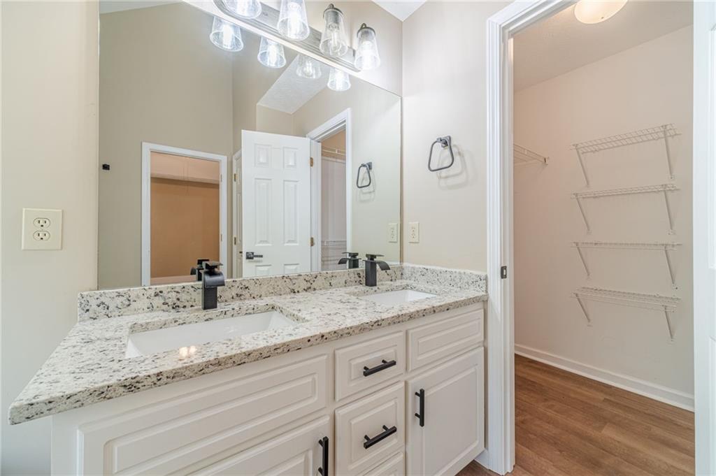 246 Azalea Farms Road Social Circle, GA 30025 - Photo 17 of 27 a bathroom with a granite countertop sink and a mirror