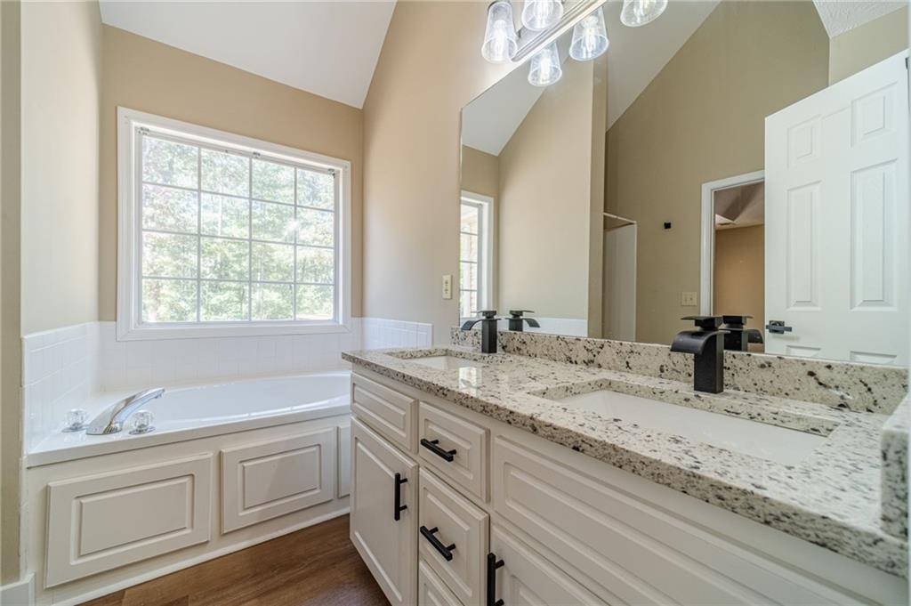 246 Azalea Farms Road Social Circle, GA 30025 - Photo 18 of 27 a bathroom with a granite countertop sink double vanity and mirror