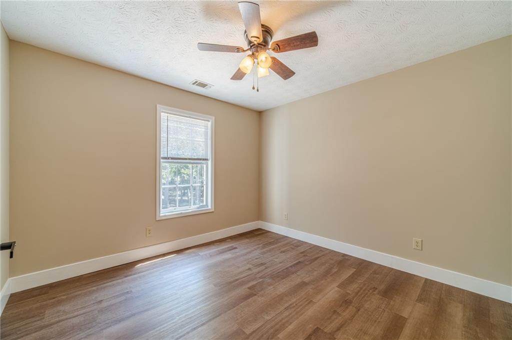 246 Azalea Farms Road Social Circle, GA 30025 - Photo 19 of 27 a view of an empty room with window and wooden floor