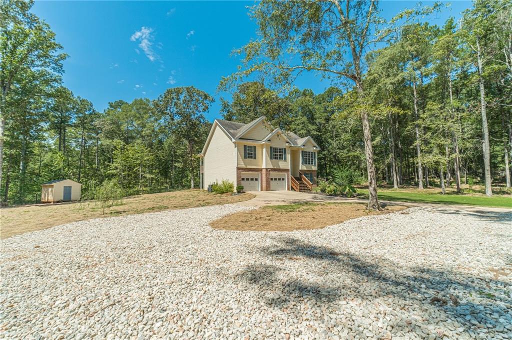 246 Azalea Farms Road Social Circle, GA 30025 - Photo 2 of 27 a view of a house with a yard and garage