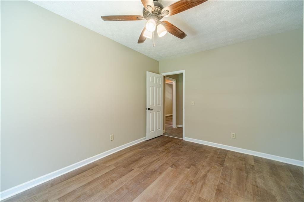 246 Azalea Farms Road Social Circle, GA 30025 - Photo 23 of 27 an empty room with a fan and a ceiling fan