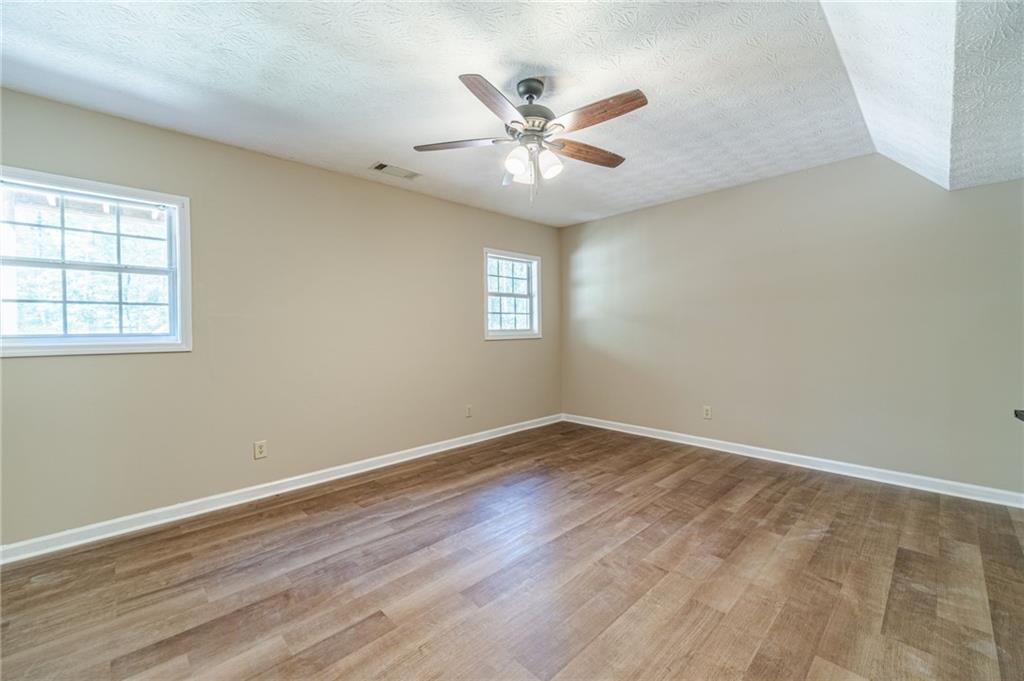 246 Azalea Farms Road Social Circle, GA 30025 - Photo 24 of 27 wooden floor in an empty room with a window