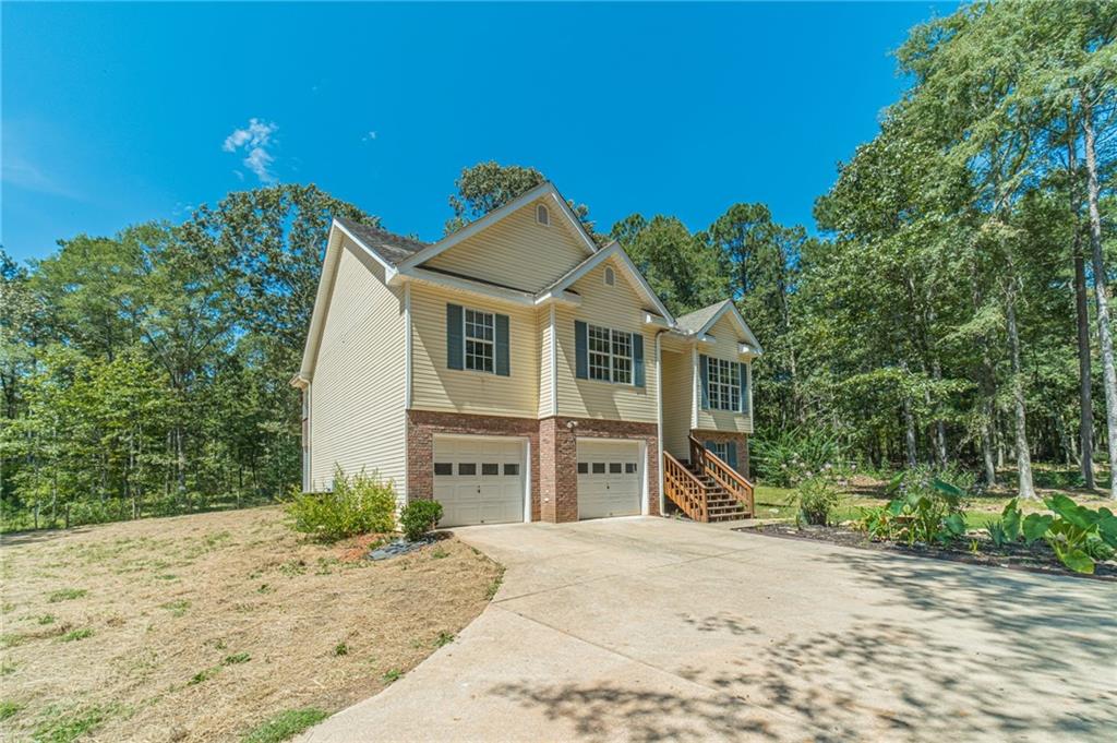246 Azalea Farms Road Social Circle, GA 30025 - Photo 3 of 27 a front view of a house with a yard and garage