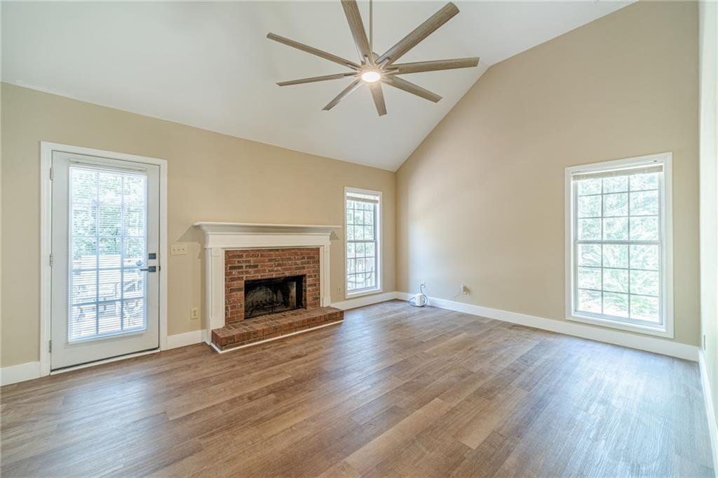 246 Azalea Farms Road Social Circle, GA 30025 - Photo 7 of 27 wooden floor fireplace and windows in an empty room