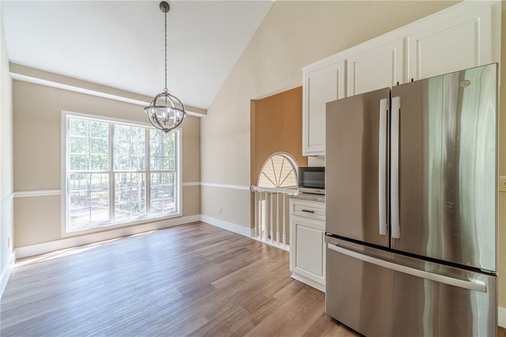 246 Azalea Farms Road Social Circle, GA 30025 - Photo 10 of 27 a kitchen with stainless steel appliances a refrigerator sink and cabinets