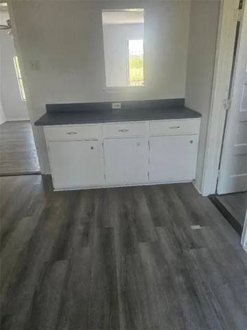 a view of a kitchen sink and cabinets