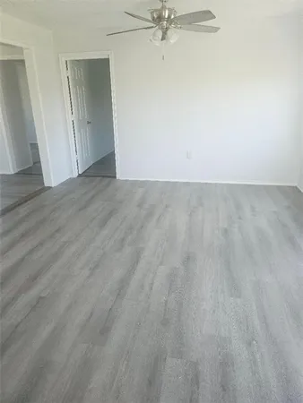 a view of a room with wooden floor