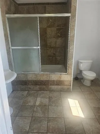 a bathroom with a toilet and a shower