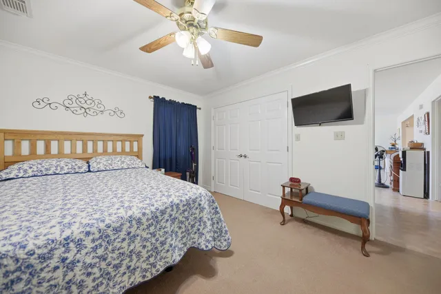 a bedroom with a bed and a chandelier