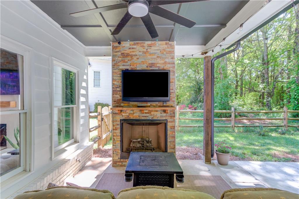 2310 Olde Hickory Place Monroe, GA 30656 - Photo 31 of 46 a living room with fireplace and a floor to ceiling window