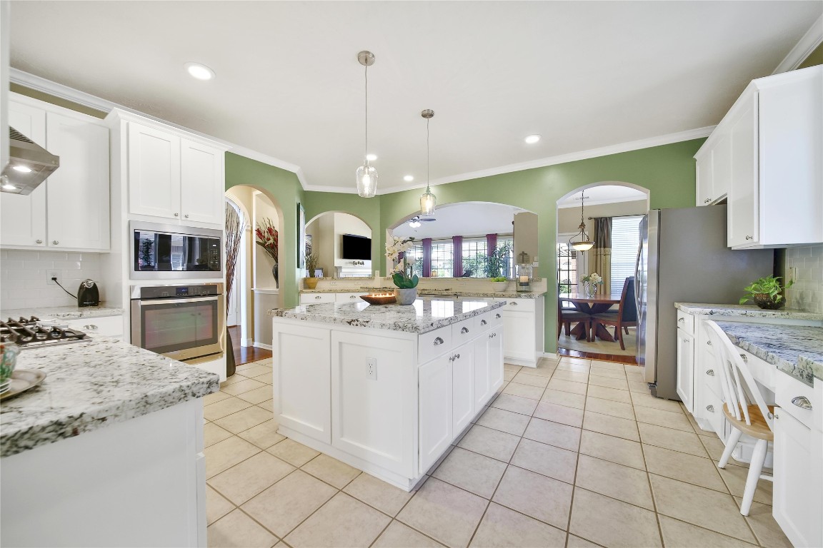 3622 Chessnut Glen Drive Spring, TX 77388 - Photo 12 of 38 a large kitchen with stainless steel appliances kitchen island granite countertop a stove and a sink