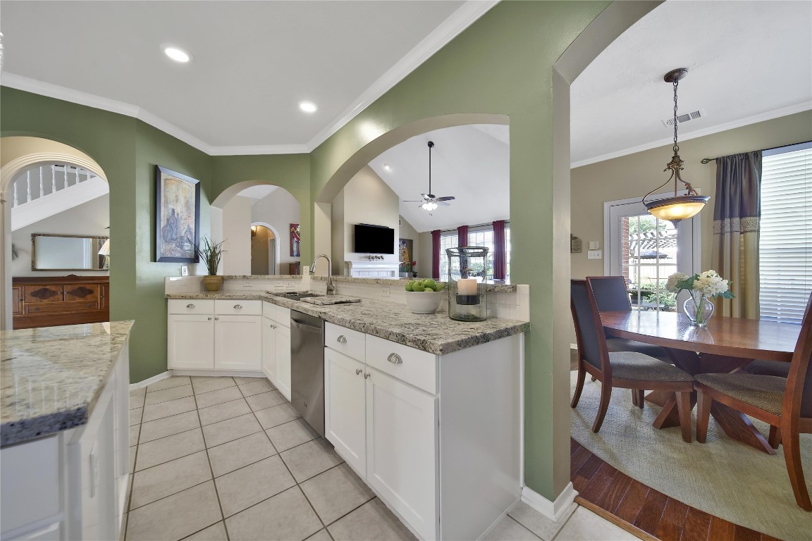 3622 Chessnut Glen Drive Spring, TX 77388 - Photo 15 of 38 a kitchen with granite countertop a sink white cabinets and glass table chairs
