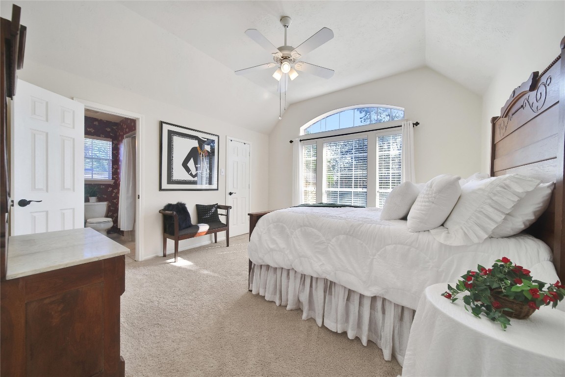 3622 Chessnut Glen Drive Spring, TX 77388 - Photo 24 of 38 a bedroom with a large bed and a chandelier