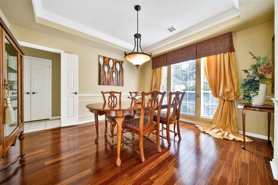 3622 Chessnut Glen Drive Spring, TX 77388 - Photo 5 of 38 a dining room with wooden floor a chandelier a wooden table and chairs