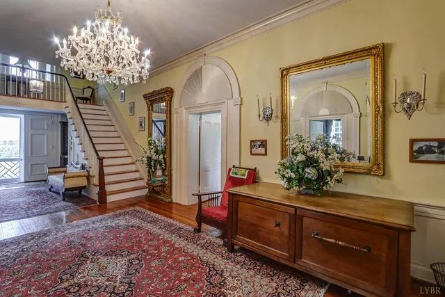 a living room with furniture and a chandelier