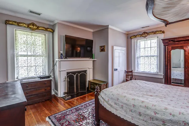 a view of a grey house with a yard