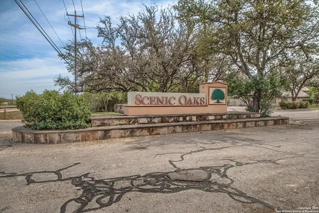 a view of a yard with wooden fence