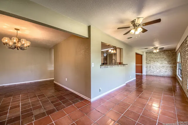 a view of a livingroom with a ceiling fan and window