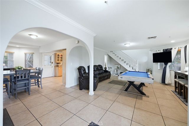 a view of a dining room with furniture and a kitchen
