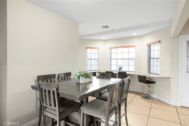 a kitchen with granite countertop white cabinets and appliances