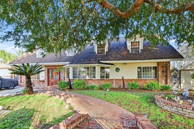 a front view of a house with a garden and plants