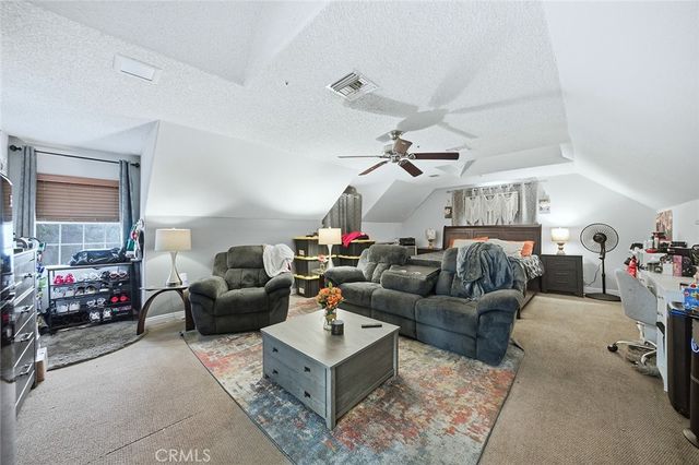 a bedroom with a large bed and a couch