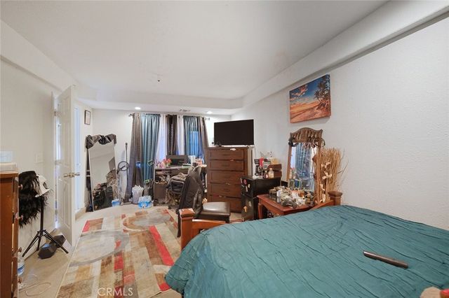 a bedroom with a bed couch and dresser