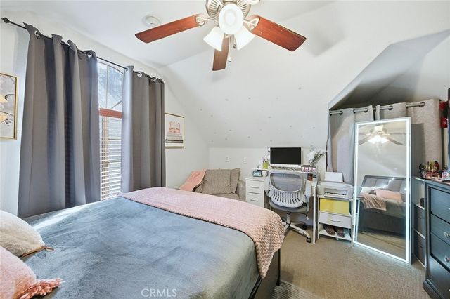 a living room with furniture a flat screen tv and a couch