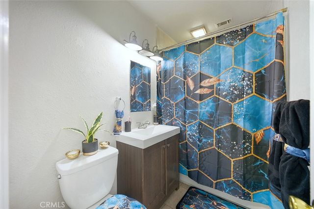 a large white kitchen with a stove a sink dishwasher and a microwave oven