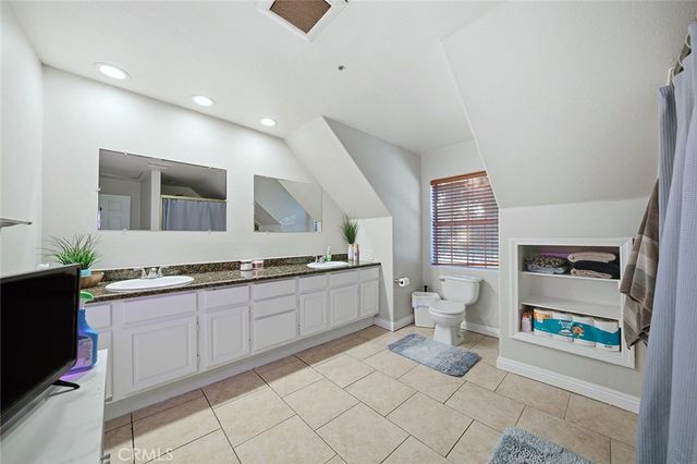 a bed room with furniture and a flat screen tv