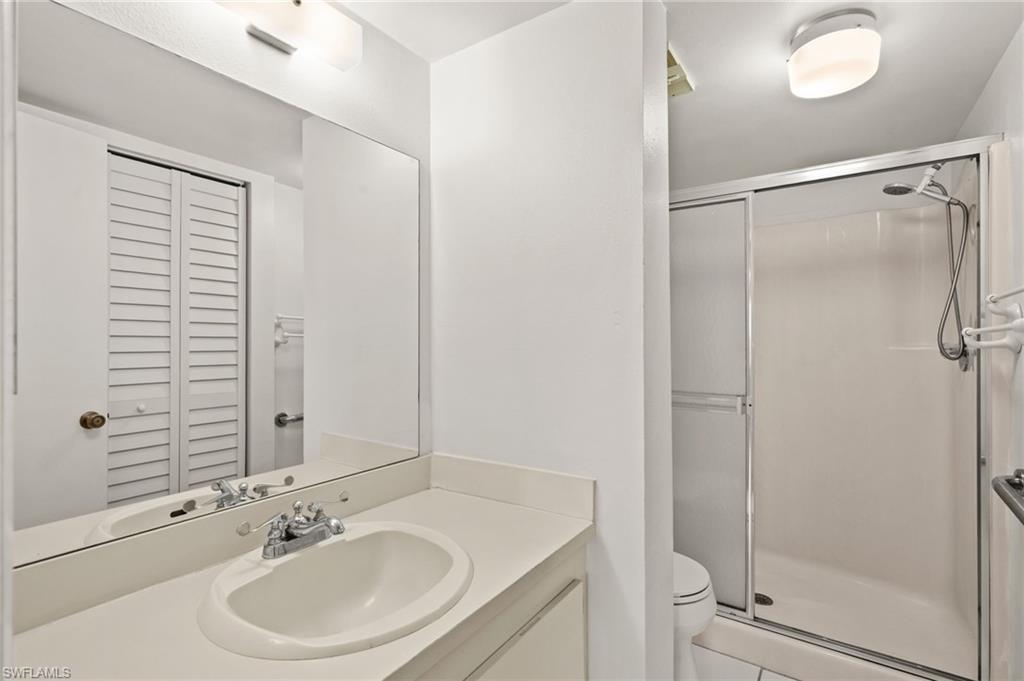 4251 27th Court Southwest, Unit 104 Naples, FL 34116 - Photo 17 of 22 a bathroom with a sink toilet and shower