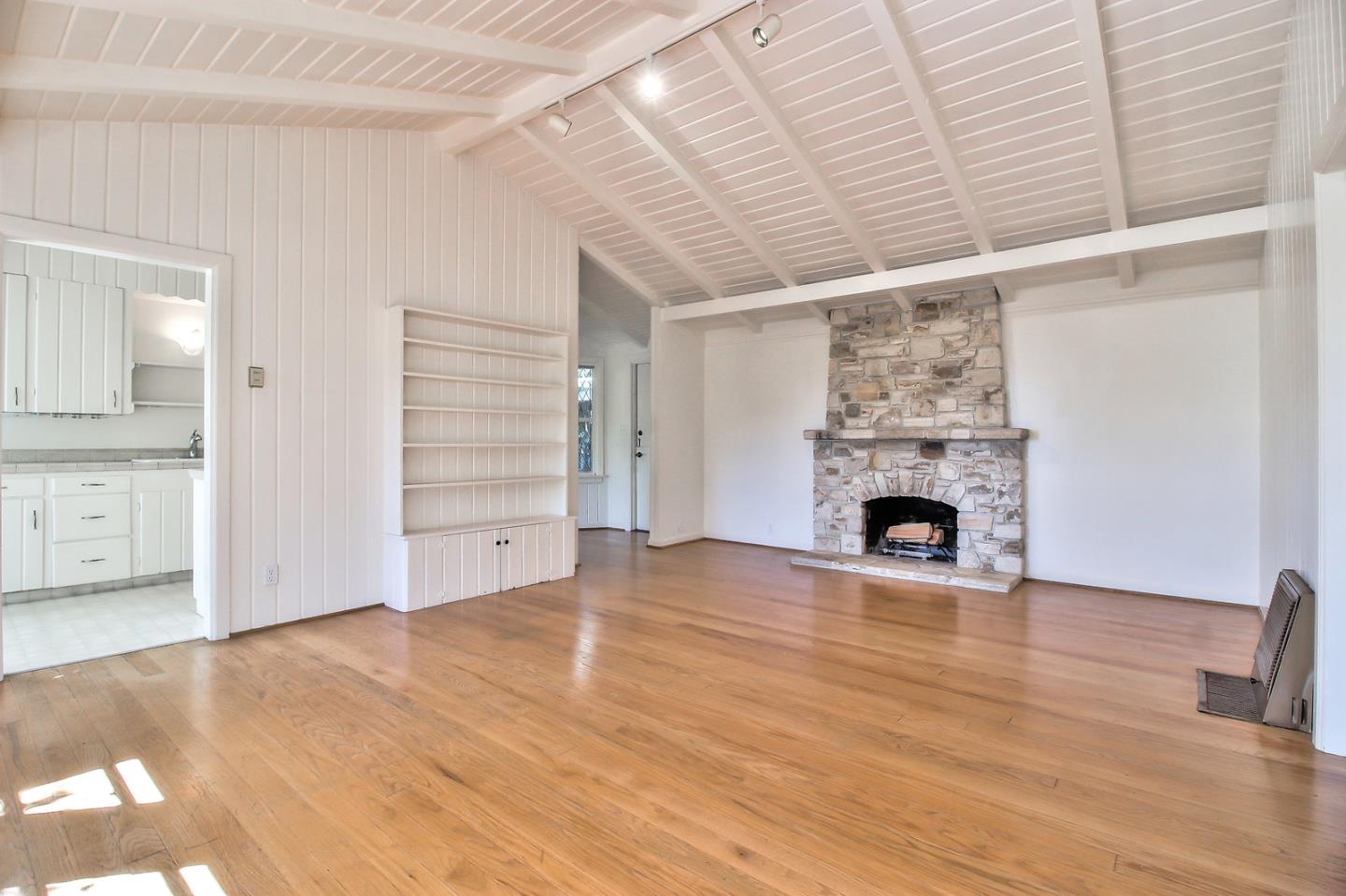2 San Carlos Street Carmel, CA 93921 - Photo 12 of 22 a view of empty room with wooden floor and fireplace