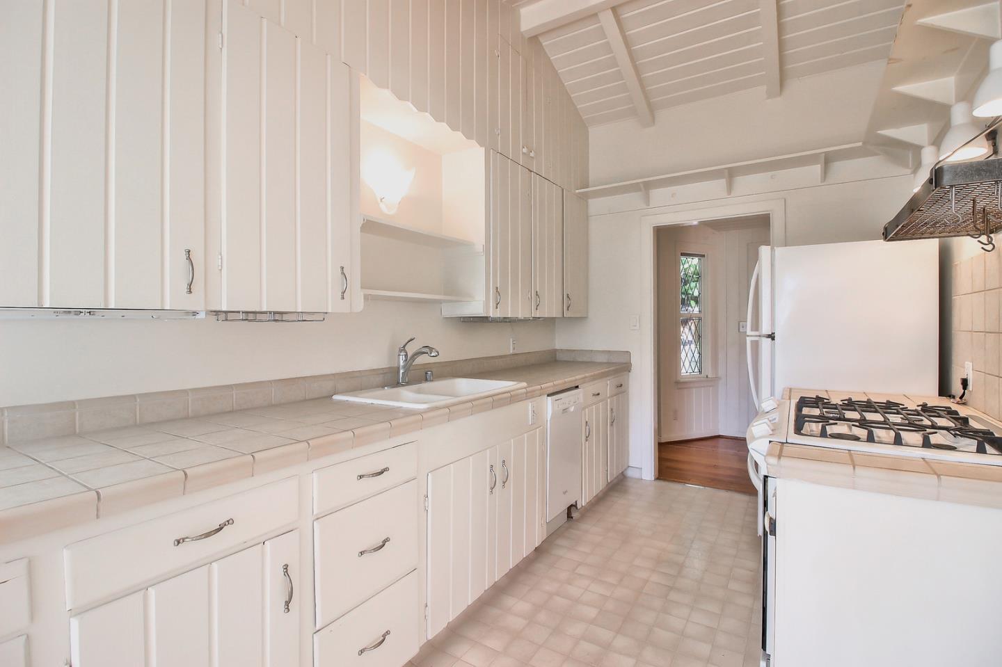 2 San Carlos Street Carmel, CA 93921 - Photo 15 of 22 a kitchen with white cabinets and appliances