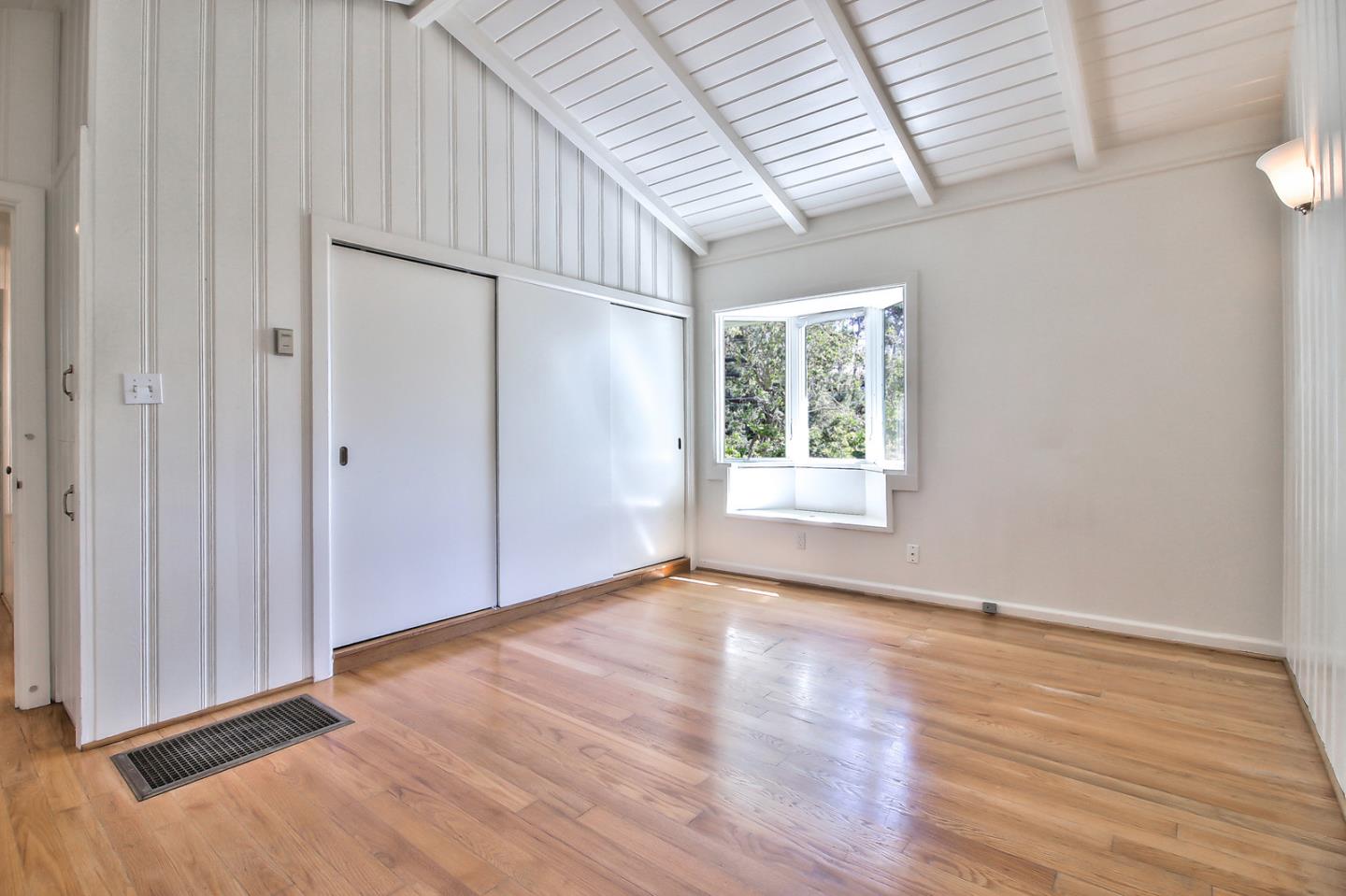2 San Carlos Street Carmel, CA 93921 - Photo 18 of 22 an empty room with wooden floor and windows