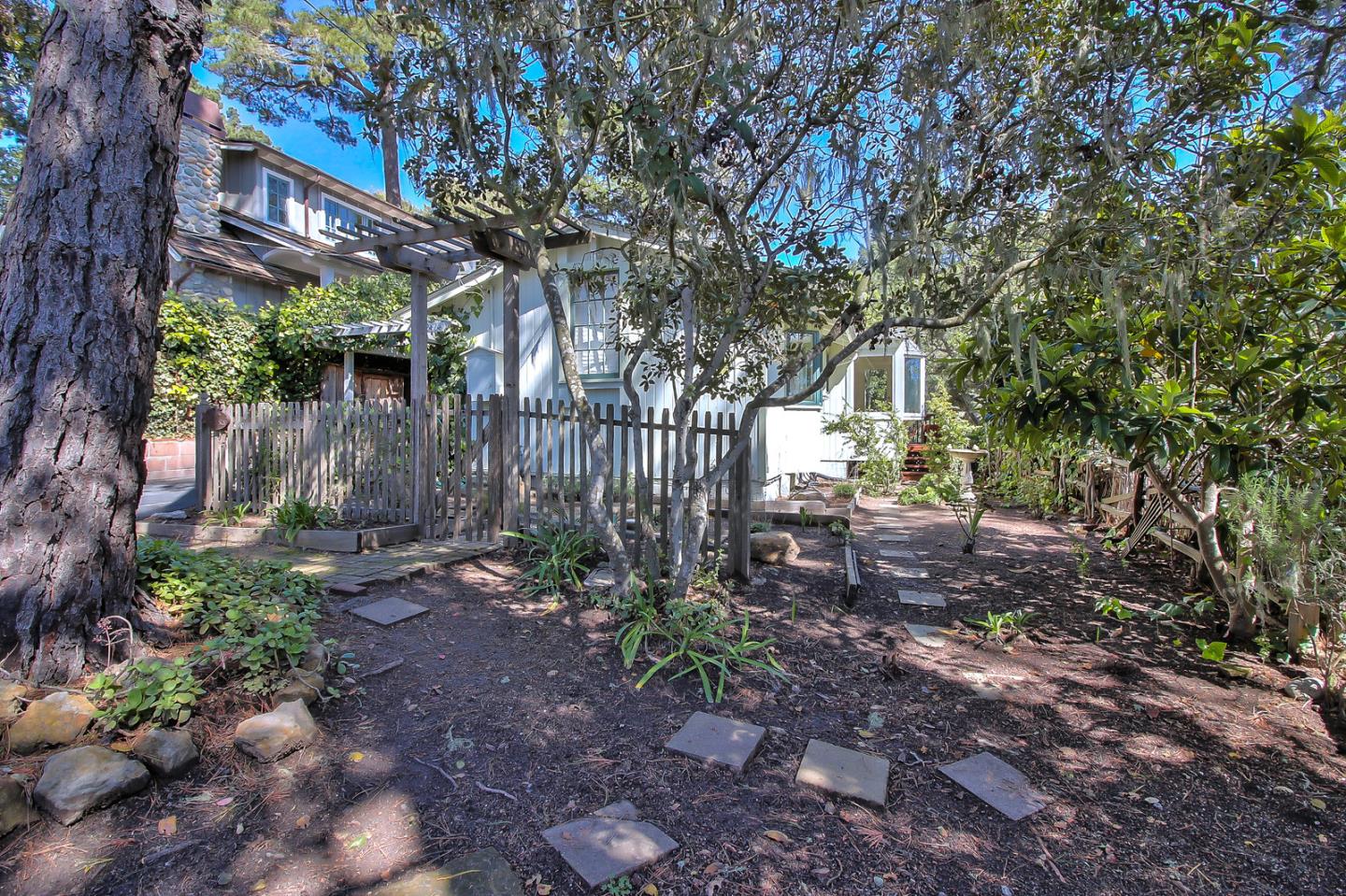 2 San Carlos Street Carmel, CA 93921 - Photo 21 of 22 a view of a backyard with plants and large trees