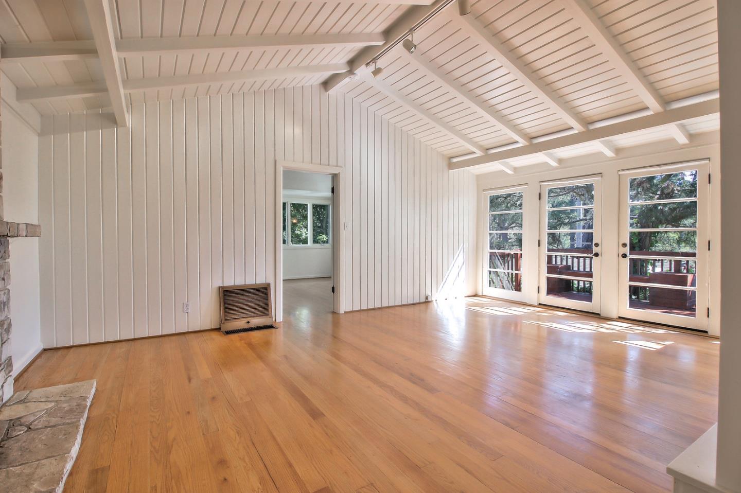 2 San Carlos Street Carmel, CA 93921 - Photo 4 of 22 an empty room with wooden floor and windows